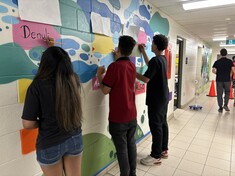 Grade 8 students painting their bricks on the Legacy Mural down the Coyote Trail